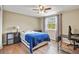 Cozy bedroom with hardwood floors, ceiling fan, and a bright window overlooking the landscape at 7376 S Jackson St, Centennial, CO 80122