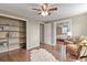 Bedroom featuring hardwood floors, ceiling fan, chair, shelving, and lots of natural light at 7376 S Jackson St, Centennial, CO 80122