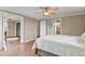 Comfortable bedroom with hardwood flooring, ceiling fan, and access to bathroom and walk-in closet at 7376 S Jackson St, Centennial, CO 80122