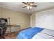 Bedroom featuring a ceiling fan, wood floor, and ample closet space with white painted doors at 7376 S Jackson St, Centennial, CO 80122