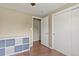 Bedroom area showcasing neutral walls, modern storage units, hardwood floors, and closet doors at 7376 S Jackson St, Centennial, CO 80122