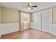 Bedroom with hardwood floors and white wainscoting details, a window, and large closet at 7376 S Jackson St, Centennial, CO 80122