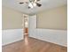 Bedroom featuring hardwood floors and white wainscoting details with a view into the bathroom at 7376 S Jackson St, Centennial, CO 80122
