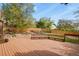 Large wooden deck with built-in benches, offering a great view of the landscaped backyard at 7376 S Jackson St, Centennial, CO 80122