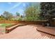 A spacious wooden deck with integrated benches overlooking a well-maintained backyard at 7376 S Jackson St, Centennial, CO 80122