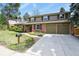 Charming two-story home with brick and siding exterior, a well-manicured lawn, and an attached two-car garage at 7376 S Jackson St, Centennial, CO 80122