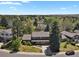Attractive two-story home with a well-manicured front yard, mature trees, and a paved driveway at 7376 S Jackson St, Centennial, CO 80122
