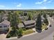 Charming two-story home featuring a lush lawn, mature trees, and an attached two-car garage at 7376 S Jackson St, Centennial, CO 80122