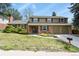 Charming two-story home with brick and siding exterior, a well-manicured lawn, and an attached two-car garage at 7376 S Jackson St, Centennial, CO 80122