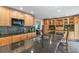 Well-equipped kitchen showcases granite countertops, custom cabinets, and a central island for meal preparation at 7376 S Jackson St, Centennial, CO 80122