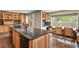 Spacious kitchen featuring wooden cabinets, a large island with a sink, and stainless steel appliances at 7376 S Jackson St, Centennial, CO 80122