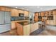 Bright kitchen with a large island, stainless steel appliances, custom cabinetry, and modern countertops at 7376 S Jackson St, Centennial, CO 80122