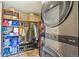 Functional laundry area features a washer, dryer, storage shelving, and closet space at 7376 S Jackson St, Centennial, CO 80122