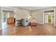 Spacious living room with hardwood floors, neutral walls, and an open doorway to the dining area at 7376 S Jackson St, Centennial, CO 80122