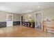 Bright living room featuring hardwood floors, wainscoting, and a bookshelf at 7376 S Jackson St, Centennial, CO 80122