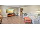 Spacious living room with hardwood floors, neutral walls, and an open doorway to the dining area at 7376 S Jackson St, Centennial, CO 80122