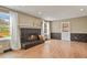 Cozy living room with a fireplace, hardwood floors, and large windows at 7376 S Jackson St, Centennial, CO 80122