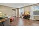 Bright living room featuring hardwood floors, natural light from large windows, and stylish decor at 7376 S Jackson St, Centennial, CO 80122