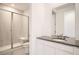 Bright bathroom with gray countertops, sink, and a modern shower at 605 Twilight St, Erie, CO 80516
