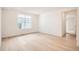 Bright bedroom with hardwood floors, neutral walls, and natural light at 605 Twilight St, Erie, CO 80516