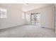 Bedroom featuring carpet floors, neutral walls, and sliding door access to outside at 605 Twilight St, Erie, CO 80516