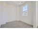 Neutral carpet in bedroom, enhanced by natural light streaming through a large window at 605 Twilight St, Erie, CO 80516