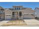 Charming two-story home with stone accents, a covered porch, and a three-car garage at 605 Twilight St, Erie, CO 80516