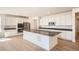Bright, modern kitchen with an island, stainless steel appliances, and white cabinetry at 605 Twilight St, Erie, CO 80516