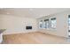 Bright living room with modern fireplace, hardwood floors, and large windows at 605 Twilight St, Erie, CO 80516