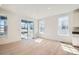 Bright living room with hardwood floors, neutral tones, and sliding glass door at 605 Twilight St, Erie, CO 80516