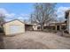 A view of the backyard garage of a home with a large tree at 7971 Olive St, Commerce City, CO 80022
