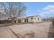 A view of the backyard of a small one-story home and shed at 7971 Olive St, Commerce City, CO 80022