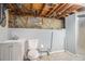 An unfinished basement bathroom with shower, sink, and toilet at 7971 Olive St, Commerce City, CO 80022