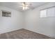 Cozy bedroom with neutral carpet, natural light, ceiling fan and freshly painted white walls at 7971 Olive St, Commerce City, CO 80022