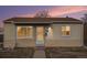 Charming single-story home featuring a quaint front door and neutral-colored siding with a serene sky at dusk at 7971 Olive St, Commerce City, CO 80022