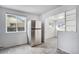 Bright kitchen with stainless steel refrigerator and open layout to adjacent room at 7971 Olive St, Commerce City, CO 80022