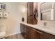 Bathroom with dual sinks, white countertops, and ample storage in the dark wood cabinetry at 7409 S Alkire St # 304, Littleton, CO 80127