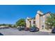 Apartment building exterior with stone accents and ample parking at 7409 S Alkire St # 304, Littleton, CO 80127