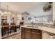 Open kitchen with quartz countertops, mosaic backsplash, and seamless flow to dining area at 7409 S Alkire St # 304, Littleton, CO 80127