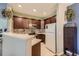 Well-lit kitchen with dark cabinets, stainless appliances, and a breakfast bar for casual dining at 7409 S Alkire St # 304, Littleton, CO 80127