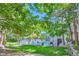 Community swimming pool surrounded by lush greenery and a secure fence at 7409 S Alkire St # 304, Littleton, CO 80127