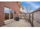 Outdoor patio area showcasing brick architecture, wooden fencing, and a sliding glass door entry at 8079 Wolff St # A, Westminster, CO 80031