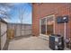 Cozy outdoor patio space with brick siding and wooden fence, perfect for relaxing and entertaining guests at 8079 Wolff St # A, Westminster, CO 80031