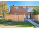 Charming brick townhome featuring a well-maintained lawn and a privacy fence at 8079 Wolff St # A, Westminster, CO 80031