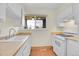 Cozy kitchen featuring bright cabinets, laminate countertops, and wood floors at 8079 Wolff St # A, Westminster, CO 80031