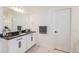 Bright bathroom with double vanities, marble floors, and modern lighting at 89 Clara Pl, Castle Pines, CO 80108