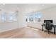 Bright bedroom area with multiple windows, light wood floors, and a dedicated desk space at 89 Clara Pl, Castle Pines, CO 80108
