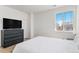 Stylish bedroom featuring a dark dresser, light-colored walls, and wood flooring at 89 Clara Pl, Castle Pines, CO 80108