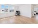 Bright bedroom area with large windows, light wood floors, and a dedicated desk space at 89 Clara Pl, Castle Pines, CO 80108