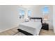 Cozy bedroom with a modern bed frame, white linens, and a contemporary black and white rug at 89 Clara Pl, Castle Pines, CO 80108